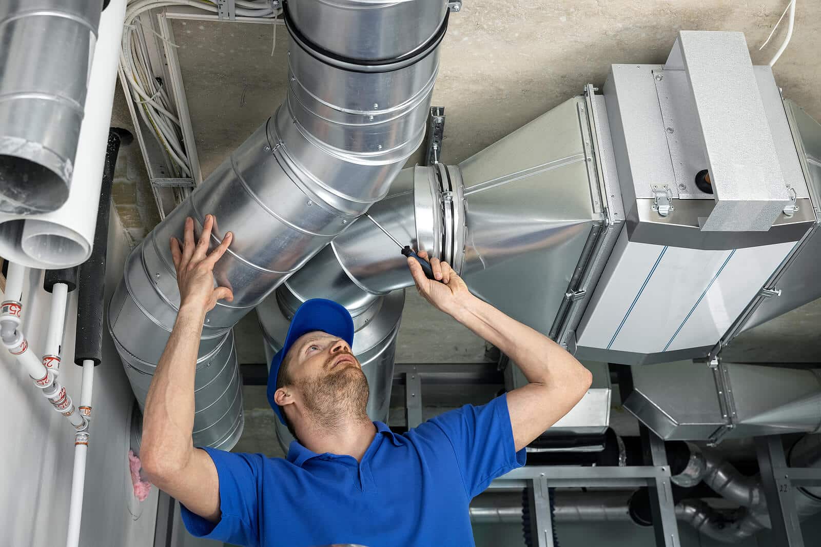 HVAC technician inspecting and repairing air ducts in Monrovia