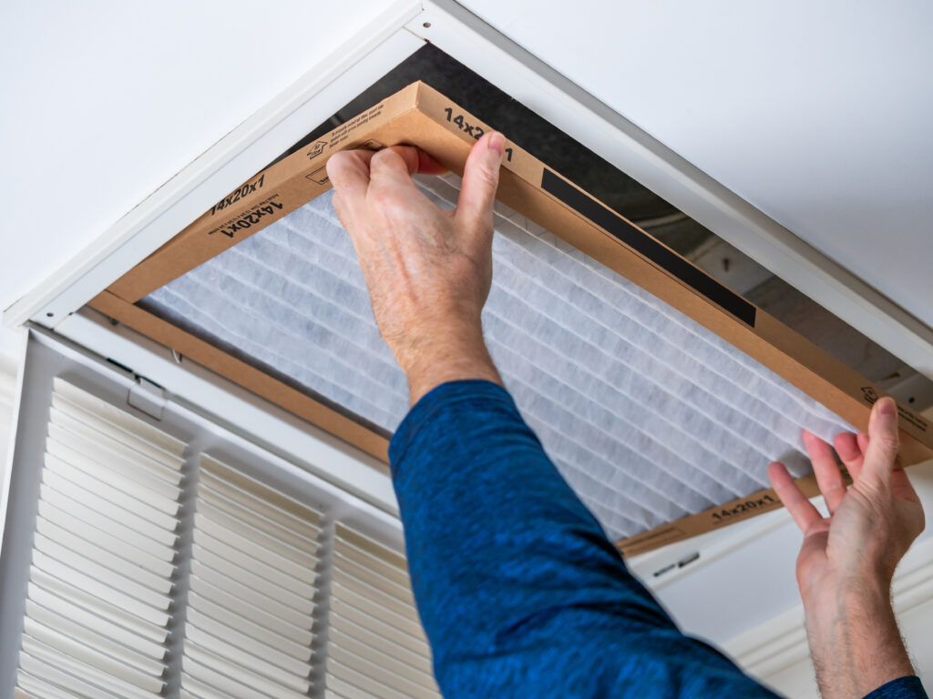 HVAC technician replacing a home air filter in Monrovia