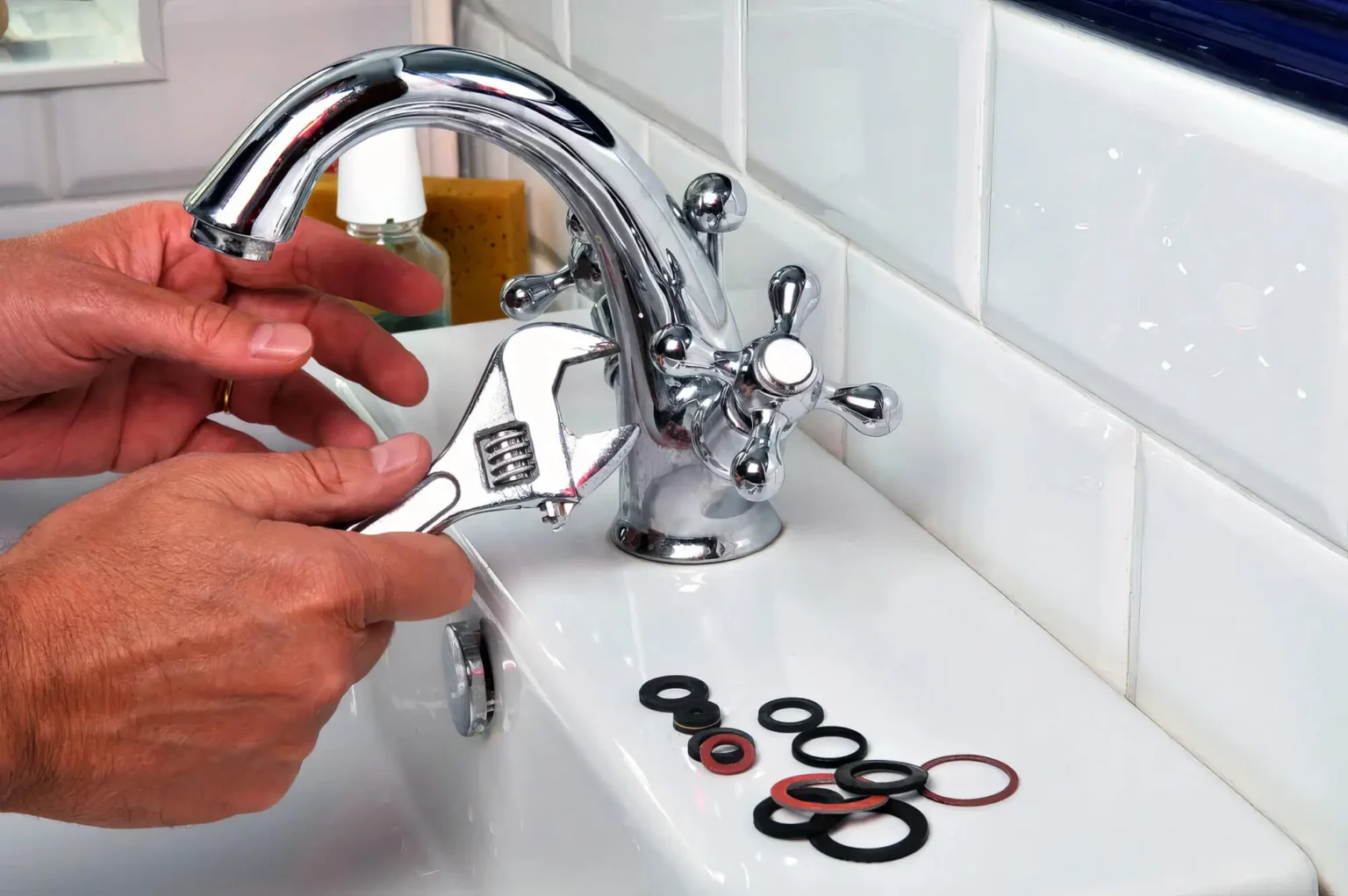 Plumber maintaining a bathroom faucet in Monrovia
