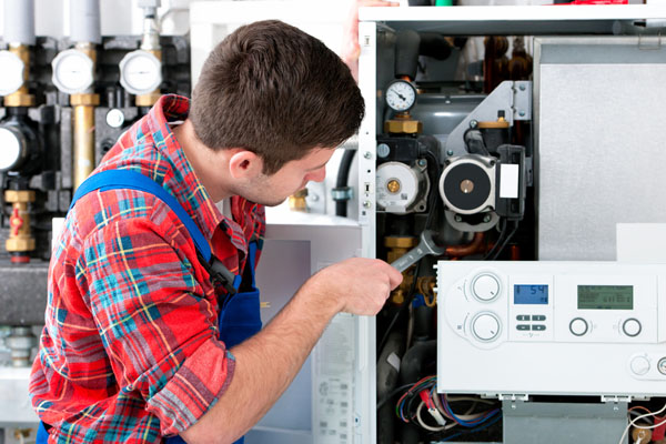 Heating technician repairing boiler controls in Monrovia