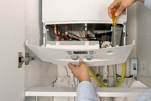 Heating technician repairing a residential boiler in Monrovia