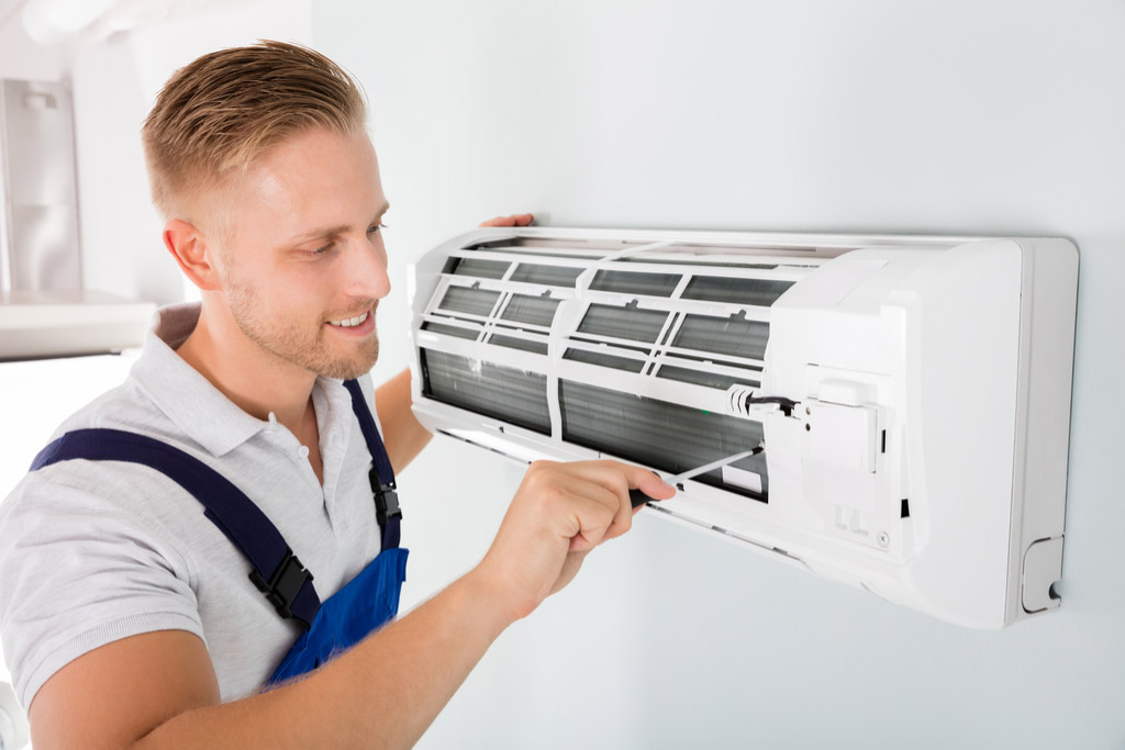HVAC technician maintaining a ductless air conditioner in Monrovia
