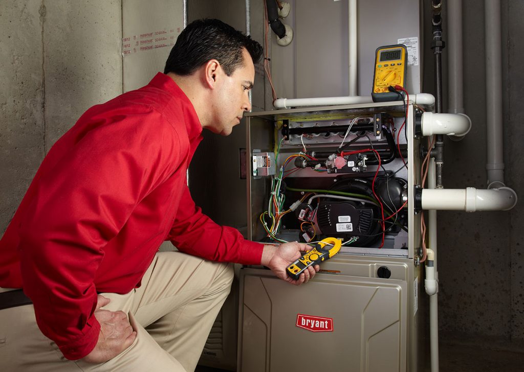 Heating technician diagnosing a furnace repair in Monrovia