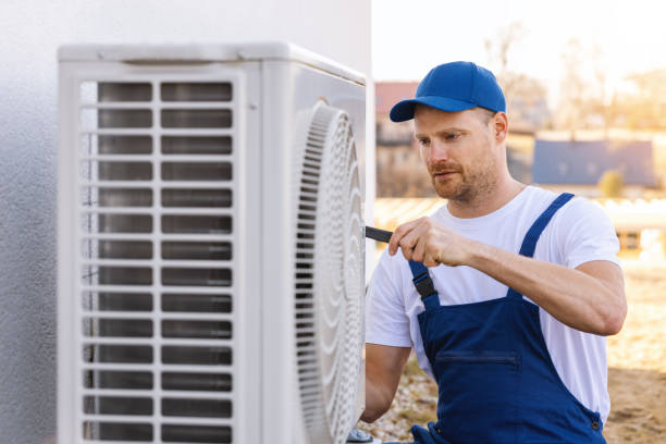 HVAC technician servicing an outdoor air conditioner in Monrovia