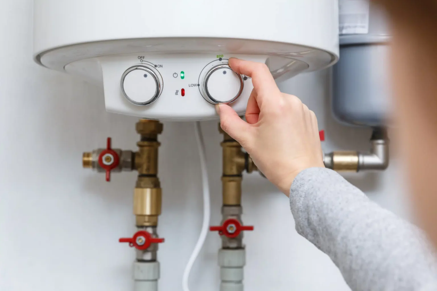 Technician adjusting a water heater in Monrovia
